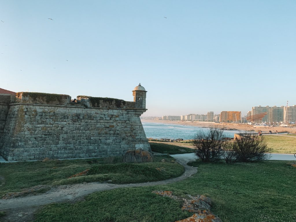 stone fortress overlooking a beach and lots of tall condo buildings