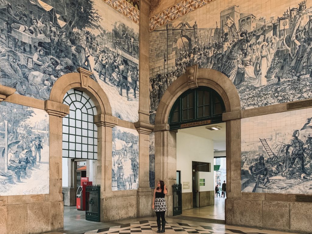 Allison Green, the editor of Eternal Arrival, looking up at the azulejos in the sao bento train station