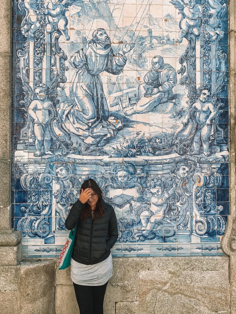 Allison Green standing in front of azulejos at the Chapel of Souls in Porto