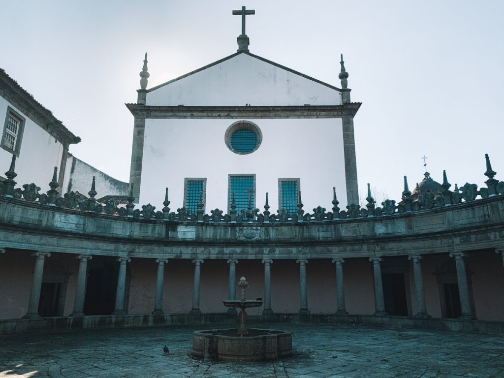 fountain with pillars making an arch around it 