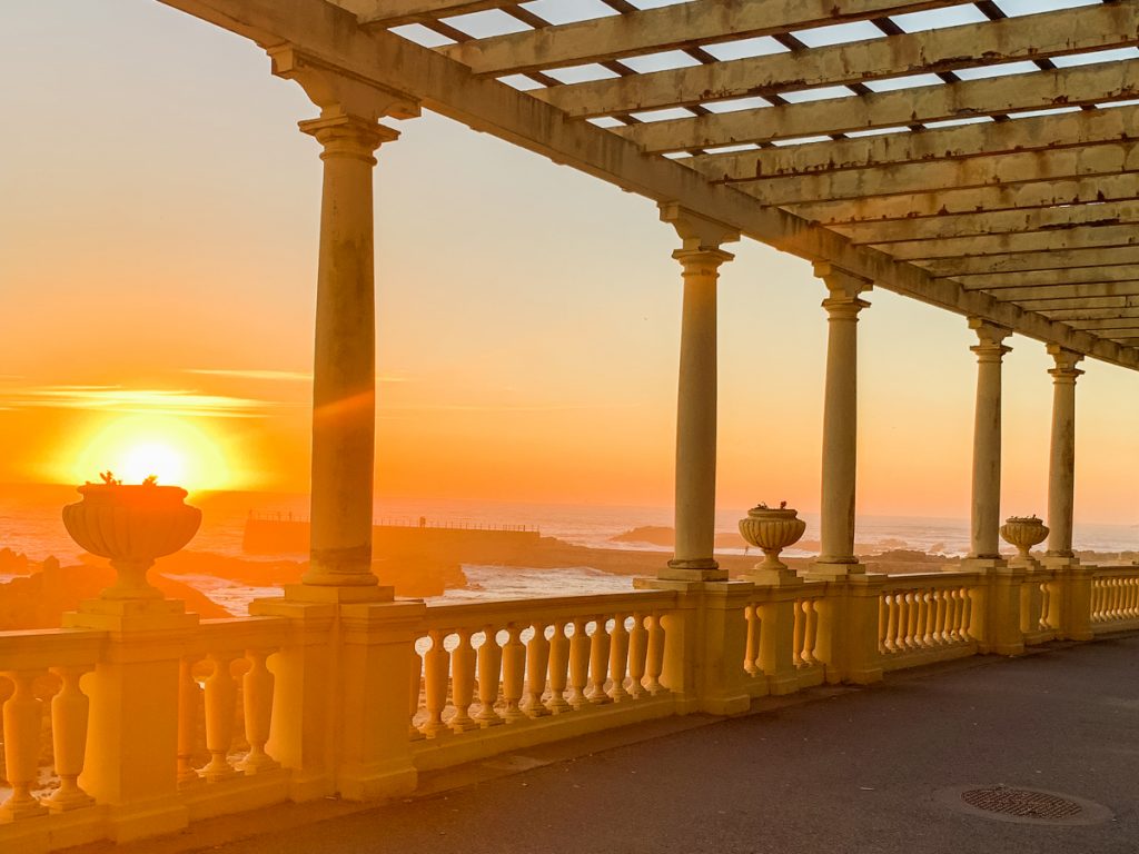 outdoor pergola at sunset with view of ocean