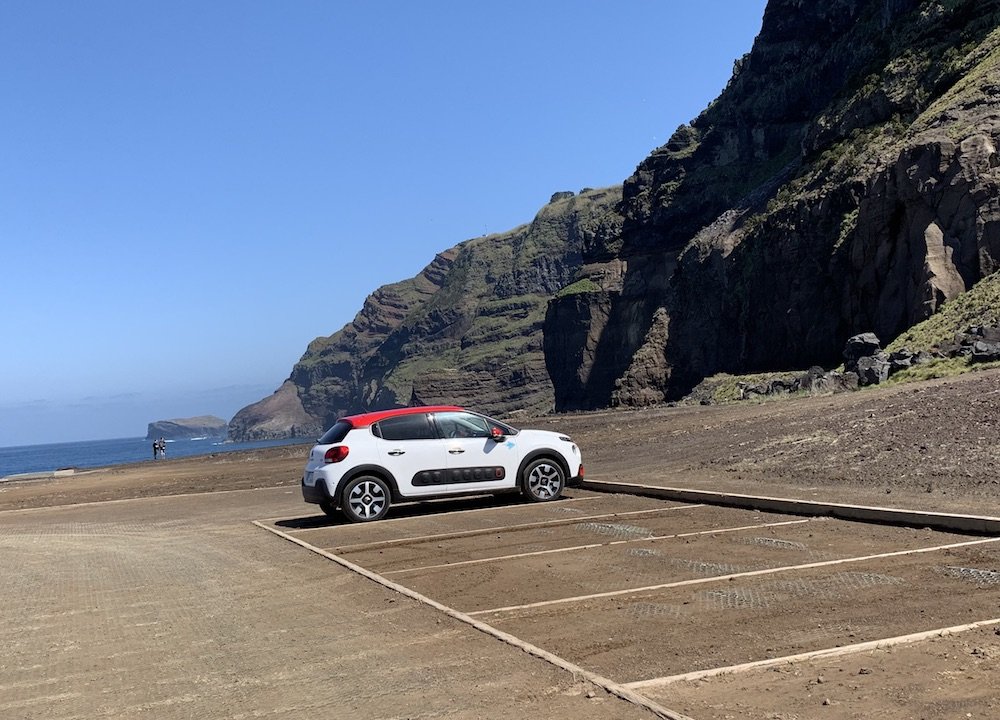 a white car with a red roof in the azores