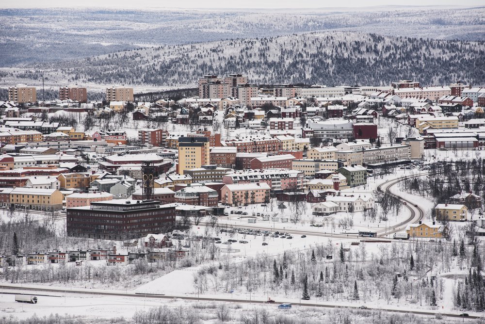 An aerial view of the city of Kiruna, the larger town near Abisko, which is the center of activity in the region. Many houses, roads, etc. in the snowy landscape.
