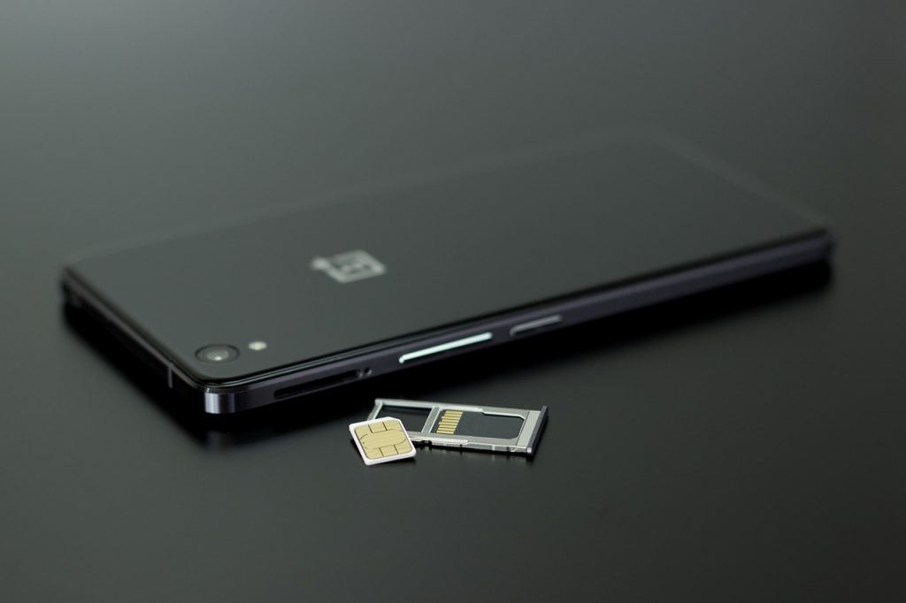 a phone with a sim card being taken out of it