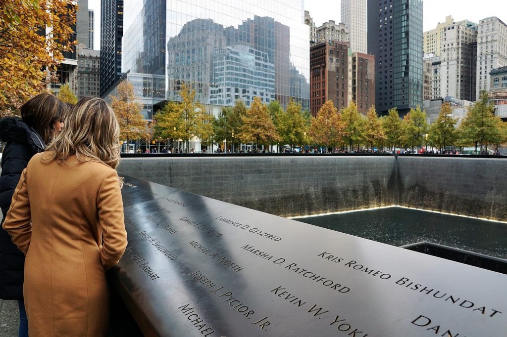 people reading names on the memorial at ground zero