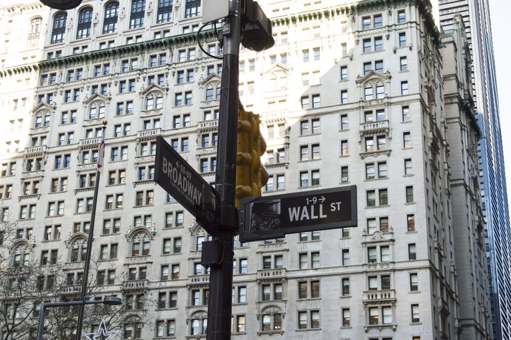 signs at the intersection of broadway and wall street in the financial district of new york