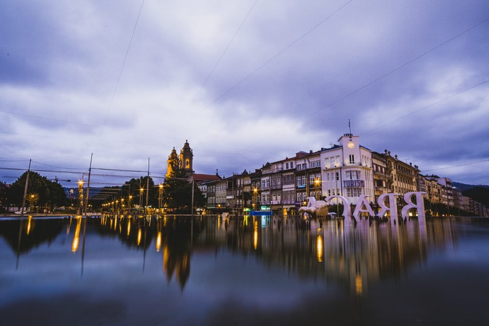 A view of Braga at night with reflecting pool and downtown