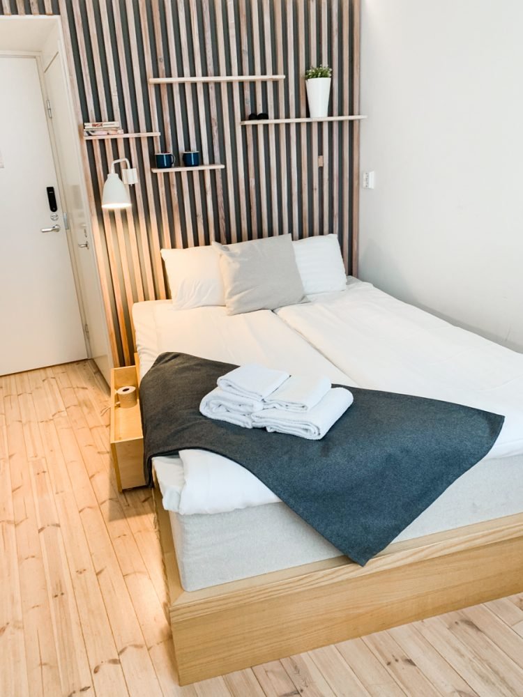 a white and wood hotel room in typical nordic style