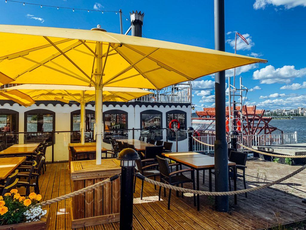 a yellow umbrella next to a steamboat style restaurant