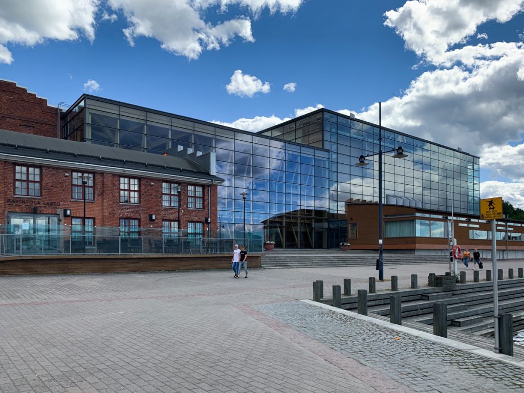 view of a half-brick, half-glass building that hosts a modern concert hall