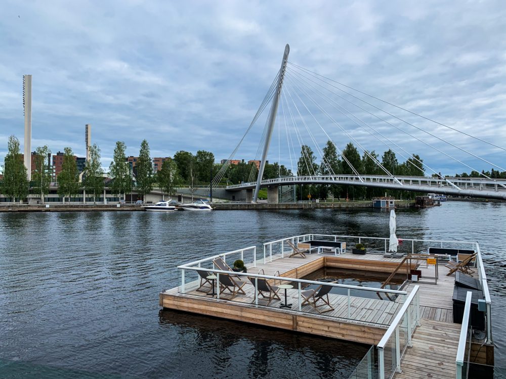 the sauna/restaurant concept of kumma on the tammerkoski channel in the summer.