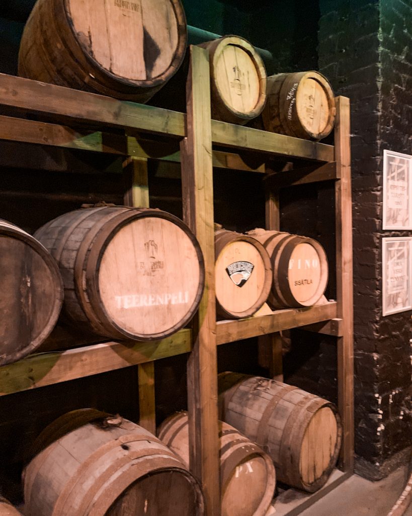 oak barrels holding different whiskeys and spirits