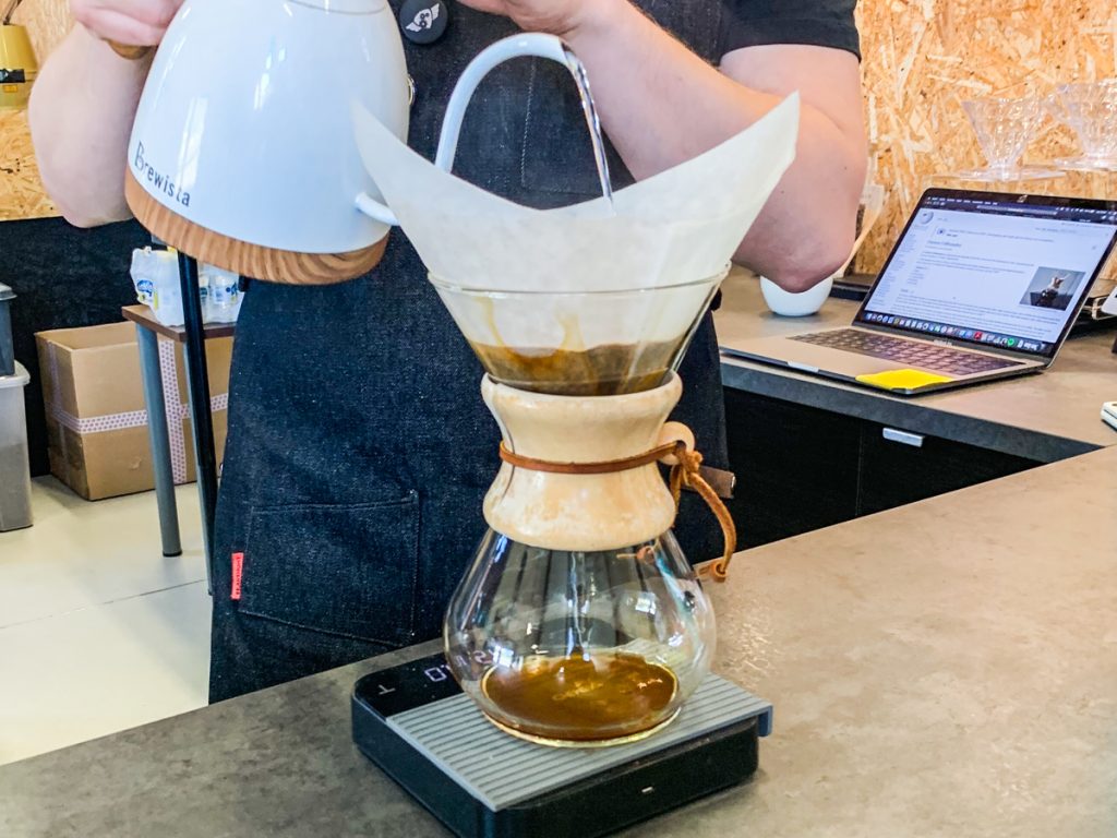 man pouring coffee into a chemex