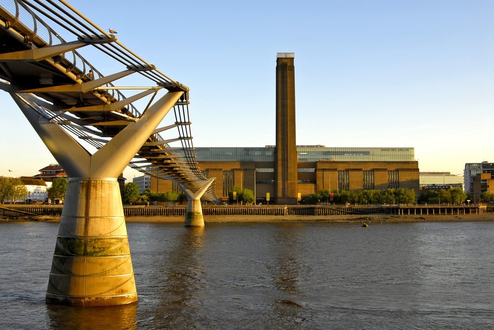 bridge leading to the tate modern and its observation tower at sunset