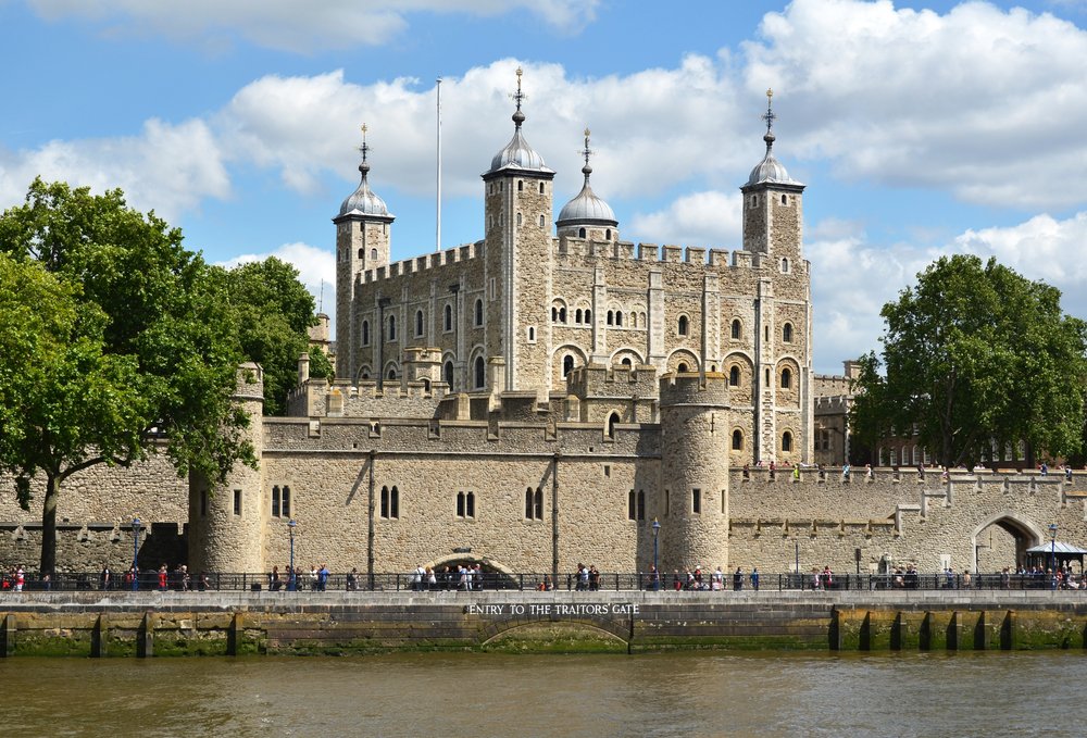 the castle-looking architecture of the tower of london with four spires: a must on any london itinerary