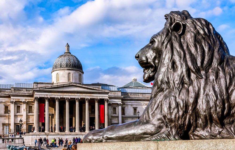 a lion statue in front of another british museum