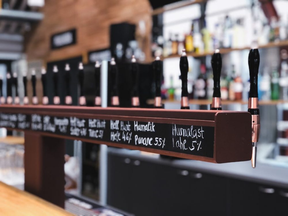 A row of taps with different Estonian beers as seen in a bar in Tallinn