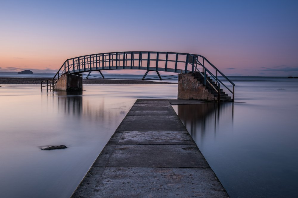 Sunset at a bridge with both entrances covered in water