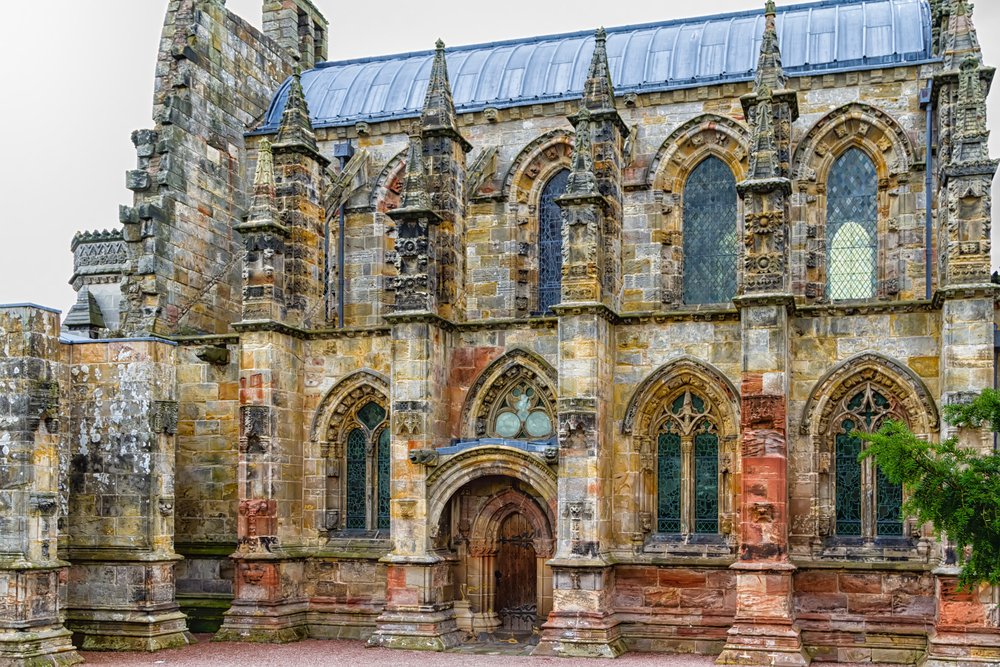 A stone chapel with archways and detailing