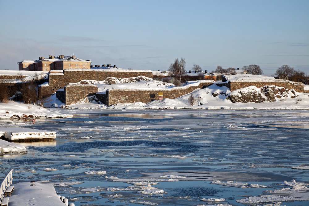 Frosty waters with ice blocks and snow-covered island fortress of Suomenlinna near Helsinki in winter