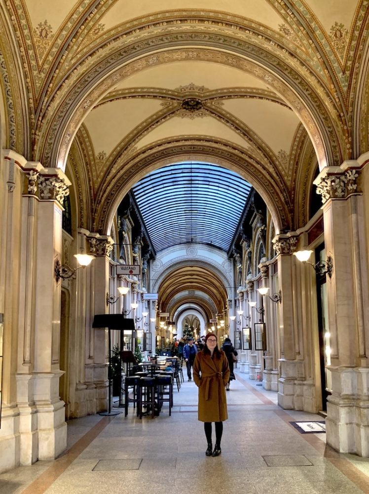 One of the few covered passageways in Vienna with Allison in a winter coat looking at the camera