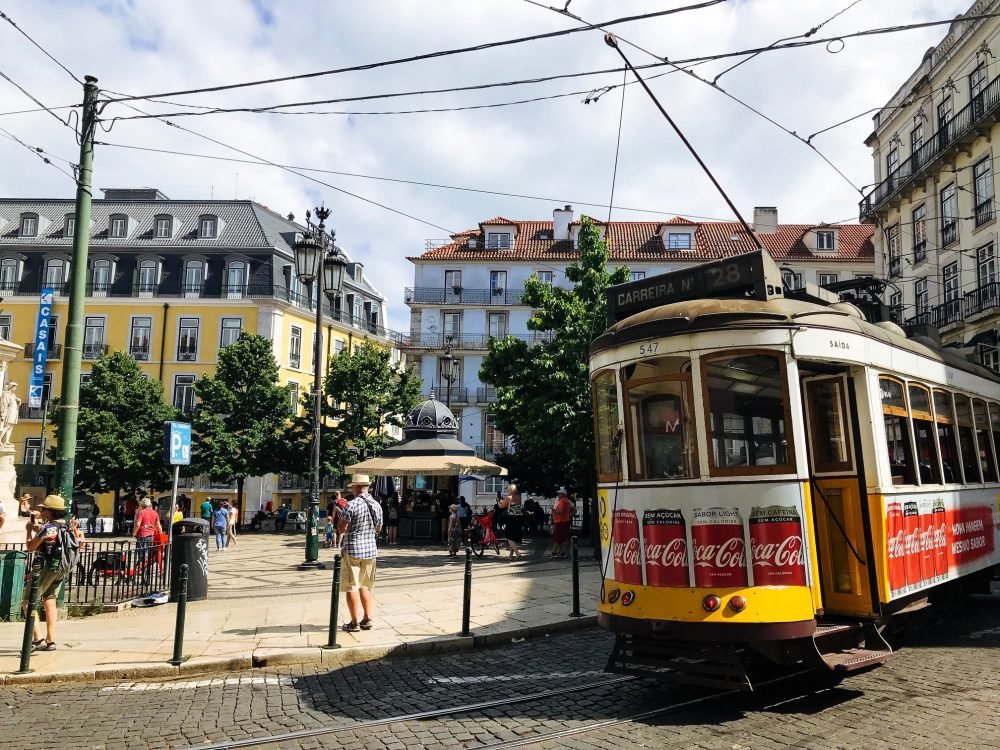 A historical yellow tram in the Chiado area of Lisbon