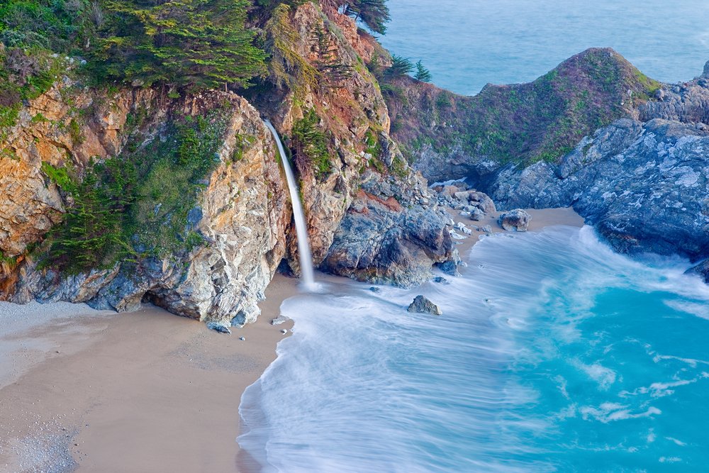 waterfall cascading into the sea at the beach long exposure