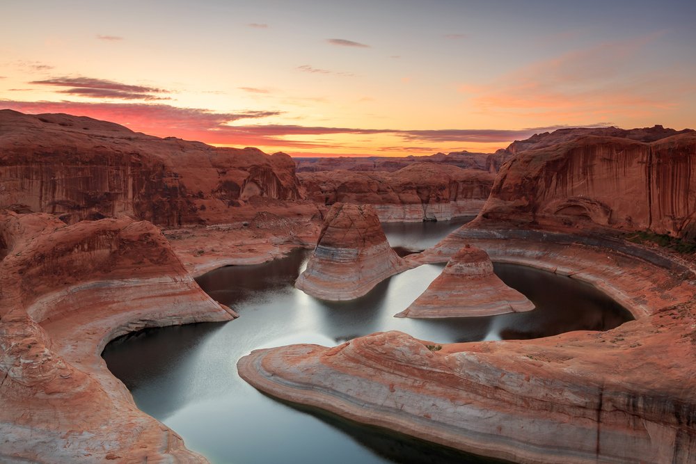 Winding river and red rock banks of Lake Powell in Utah