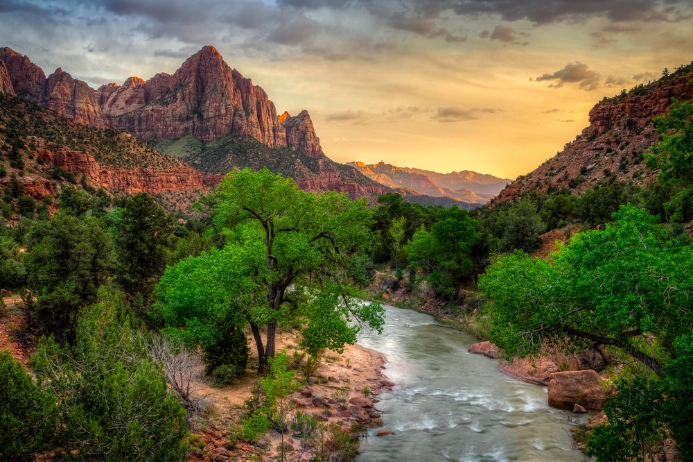 Sunset over Zion National Park with a river and Watchman Mountain