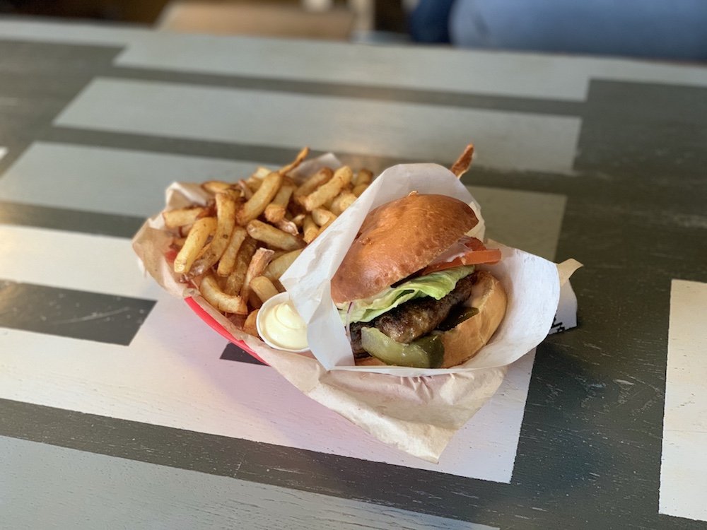 a burger and fries at the local burger joint in tromso on a metal table