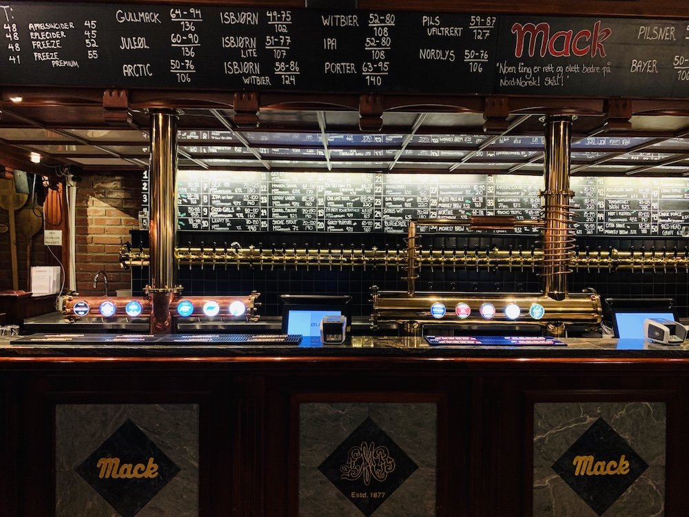interior and bar scene at the olhallen pub, where they serve mack beer and other varieties of beer on tap