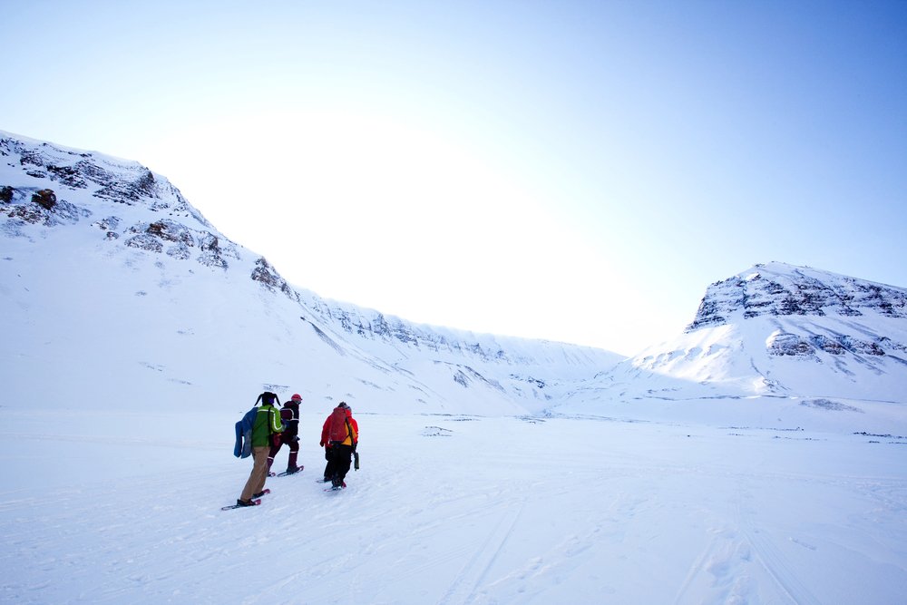 A group of three friends snowshoeing in the Tromso area