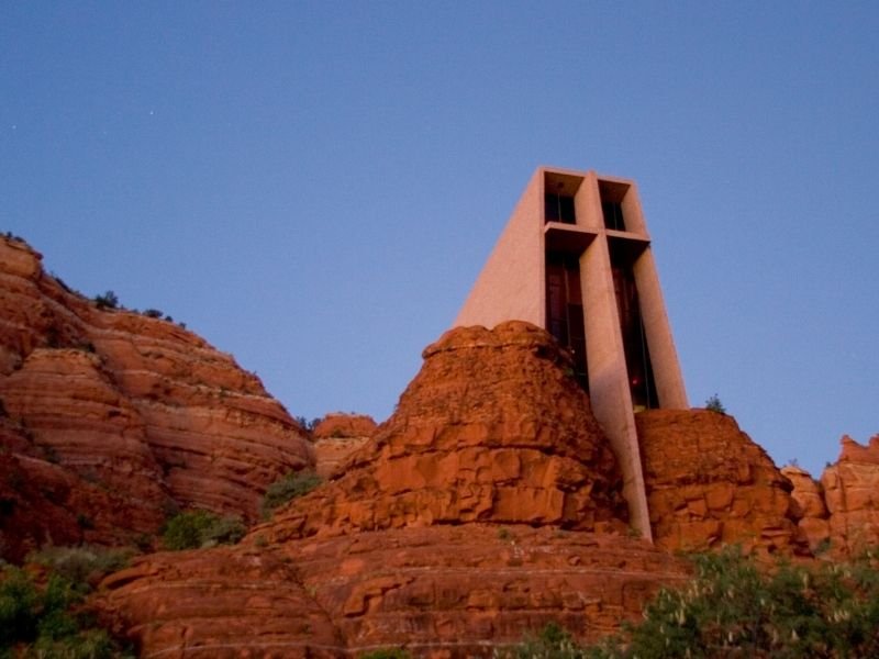 the famous chapel in the rocks of sedona which blends into the natural scenery after dark