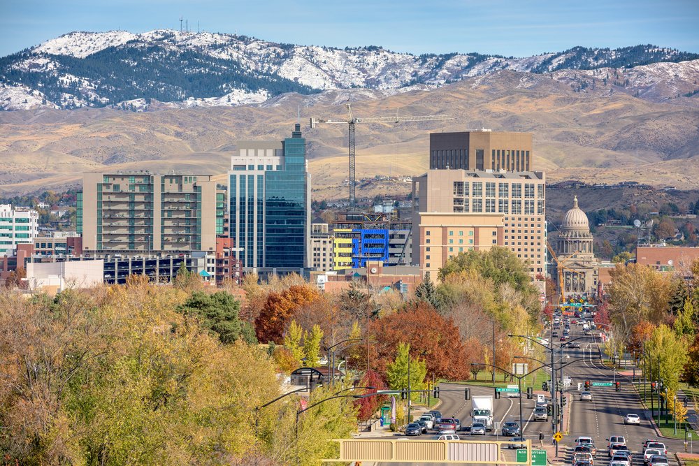 View of downtown Boise with lots of buildings and a busy road in the autumn as the colors change on the fall trees, 