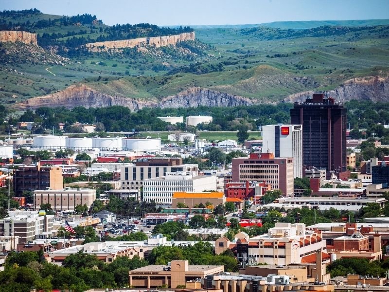 The landscape of downtown Billings, Montana: buildings against greenery and plateaus