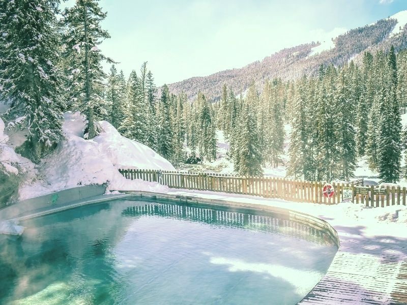 A view of the famous Granite Hot Springs near Jackson in Wyoming covered in snow with pine trees everywhere.