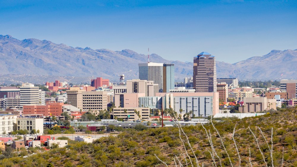 Buildings that make up the skyline of Tucson Arizona with mountains in the background - your first stop on this Arizona road trip itinerary.