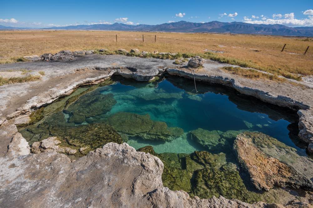 Brilliant turquoise hot spring in the middle of nowhere in Utah.