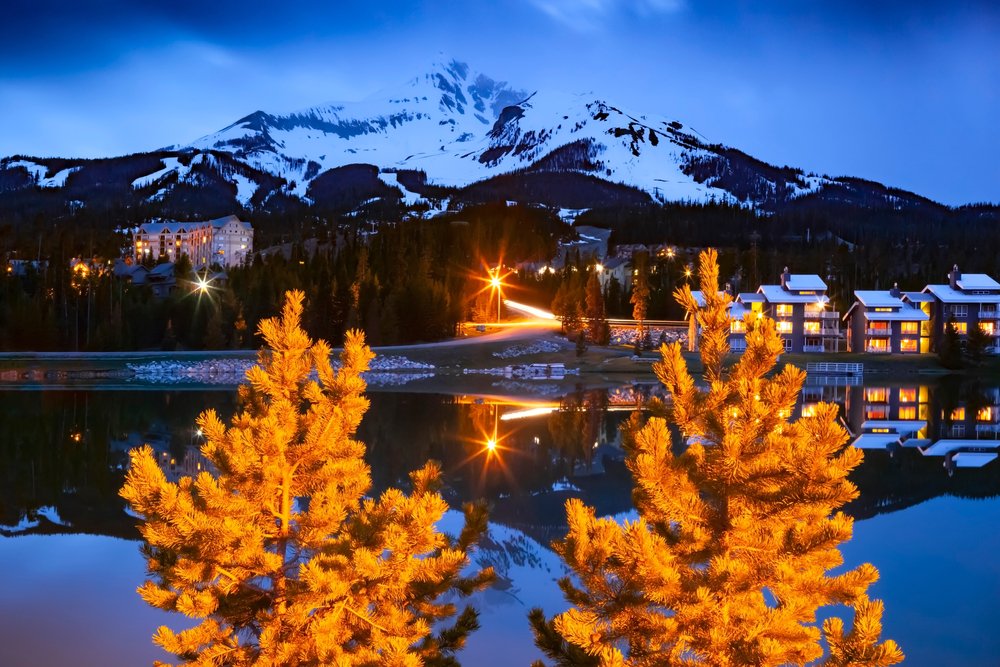 Two festive lit up trees at Christmas time in the ski resort town of Big Sky Montana