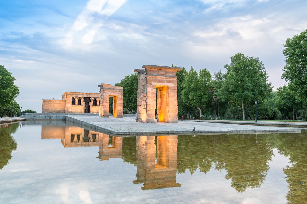 A few arches and a larger stone edifice that make up the Temple of Debod, an actual Egyptian temple in Madrid.