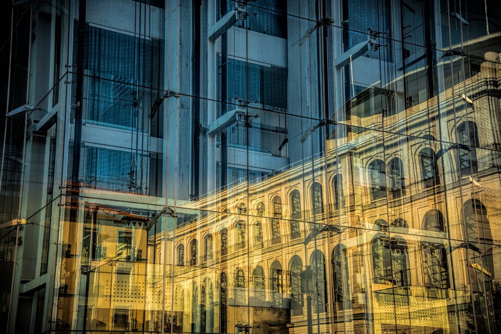 Reflection of a traditional architecture building reflected by a modern building