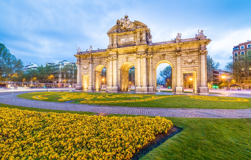 Lit up arch with flowers in front in Madrid