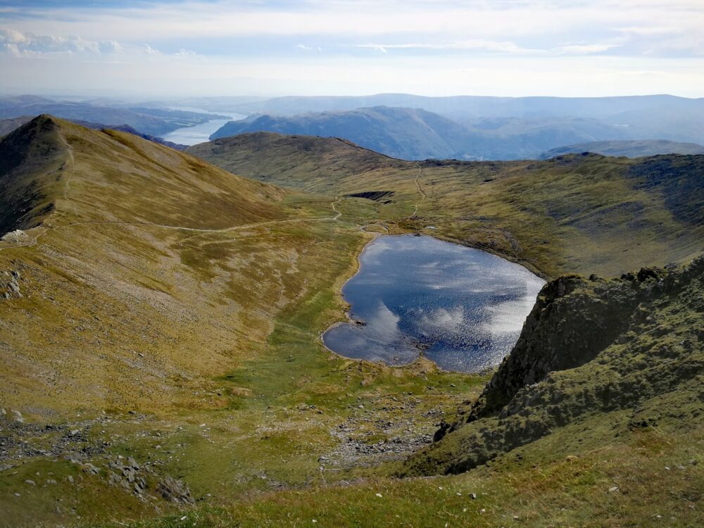 Helvellyn summit looking down to Red Tarn in the Lake District