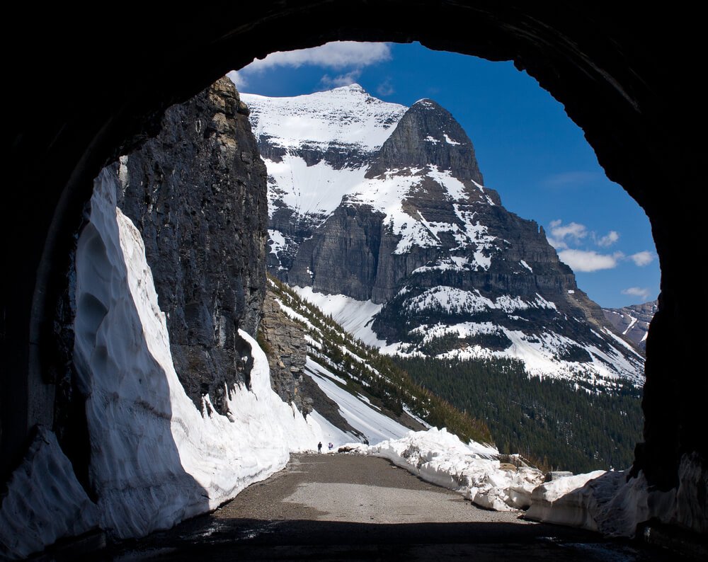 Going to the Sun Mountain from the East Tunnel of the Going to the Sun Road, the sides of the mountain are covered in a light snow, road has been plowed before the road closes in Glacier National Park in winter.