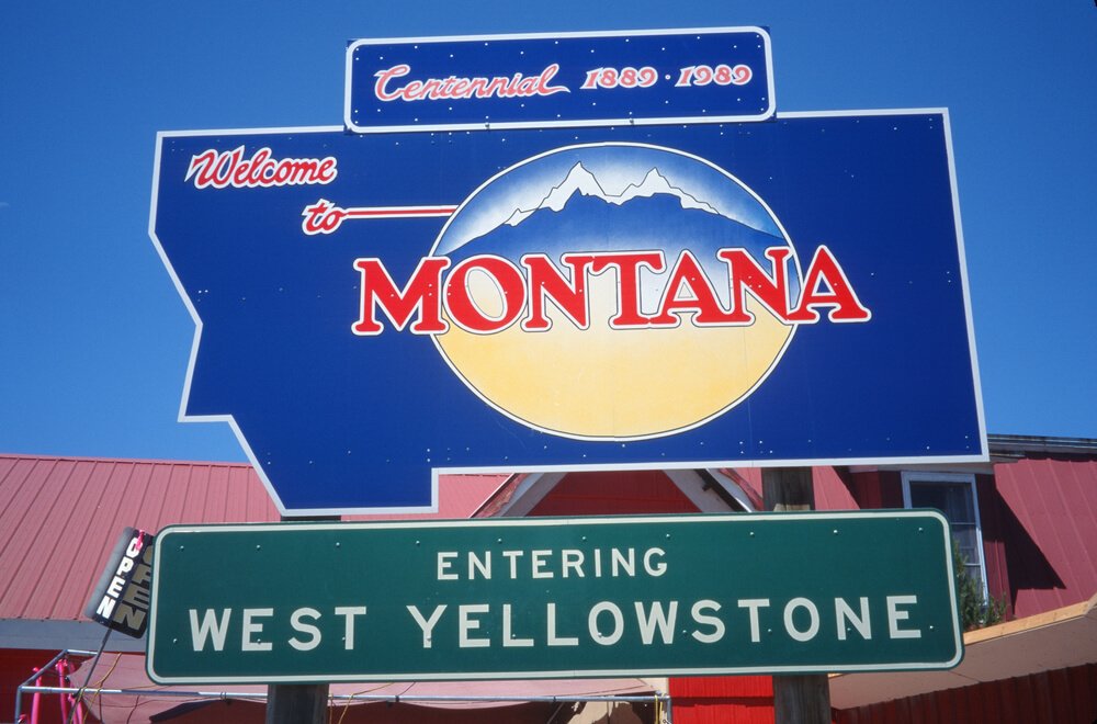 Sign that reads "Welcome to Montana, entering West Yellowstone".