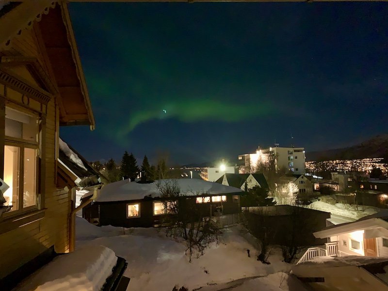 Faint northern lights occuring in the city center of tromso, seen from the balcony of the Airbnb Allison stayed in during her trip to Tromso.