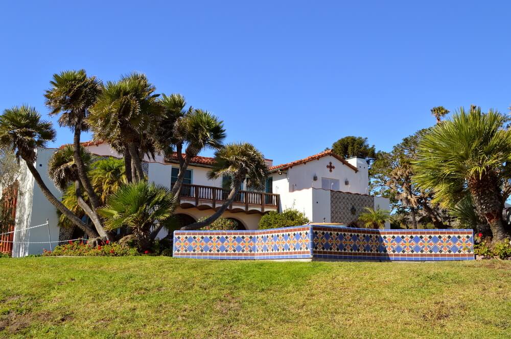 The backyard of the Adamson house with Mediterranean style detailing and tilework and lots of trees