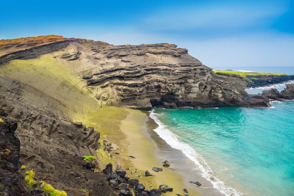 the waters of the green sand beach of hawaii with turquoise water