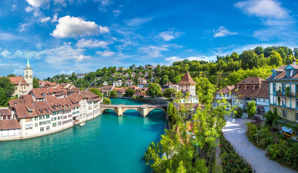 the beautiful aare river which is turquoise and calm flowing through the heart of the old town of bern, the swiss capital city