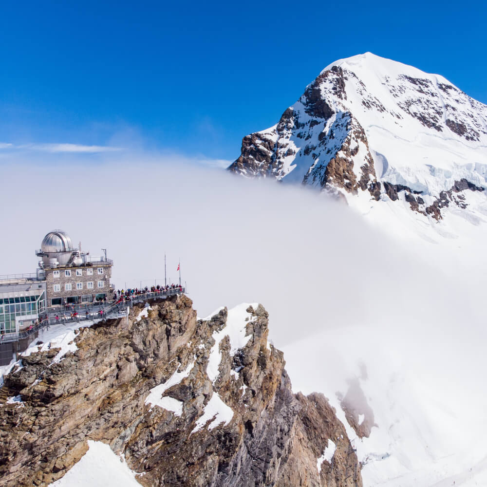 The station at the Top of Europe, Jungfraujoch, on a cloudy day with a view of a mountain in the distance